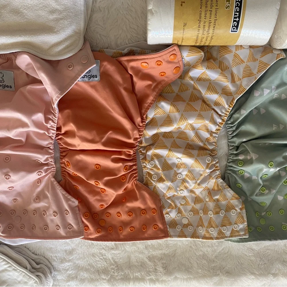 17 pocket cloth diapers + inserts, liners, and storage bags
